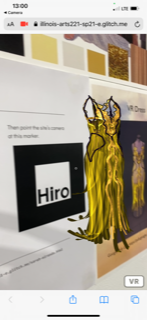 In a
            mobile browser, a gold dress floats in front of a piece of
            paper.